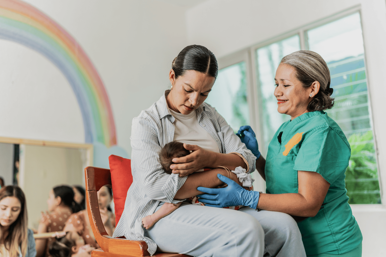 Lactation consultant helping a mother position her baby for breastfeeding.