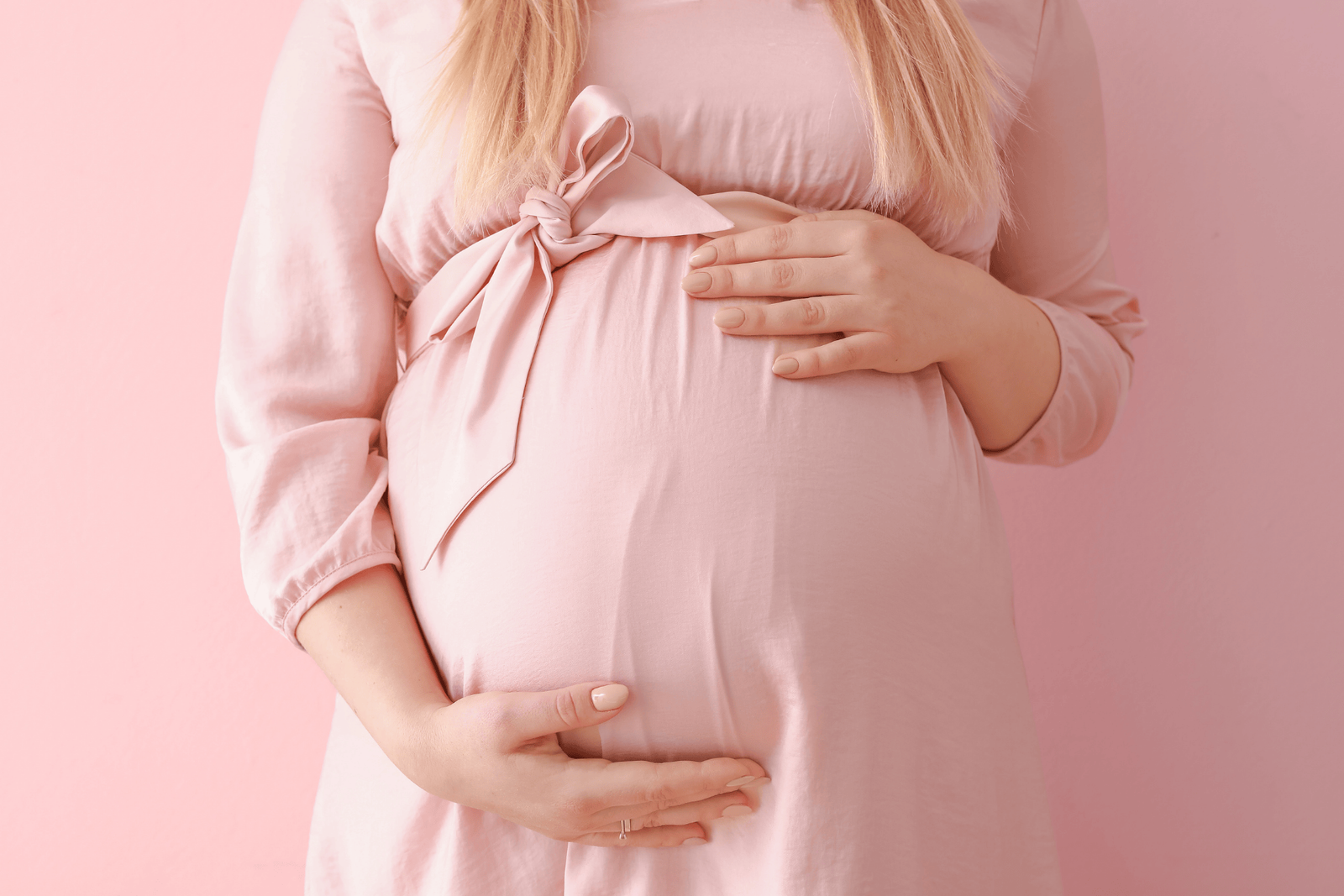 Close-up of a pregnant woman in a pink dress