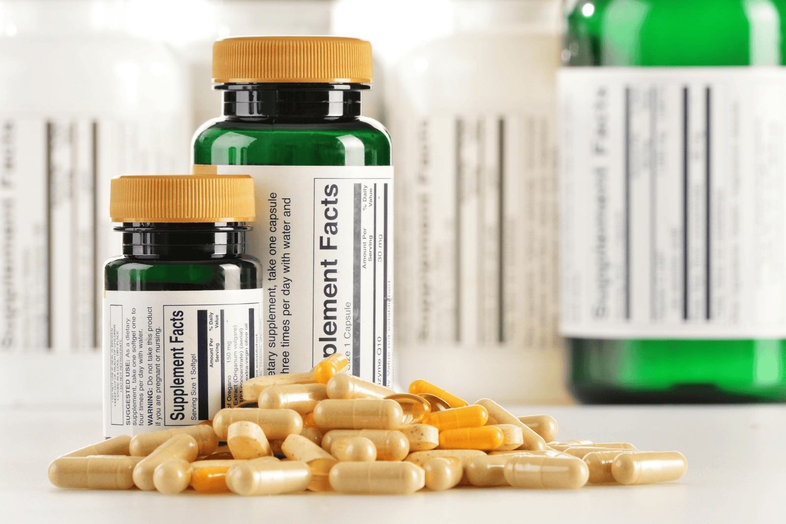 Bottles of papaya enzyme supplements with capsules scattered in front.
