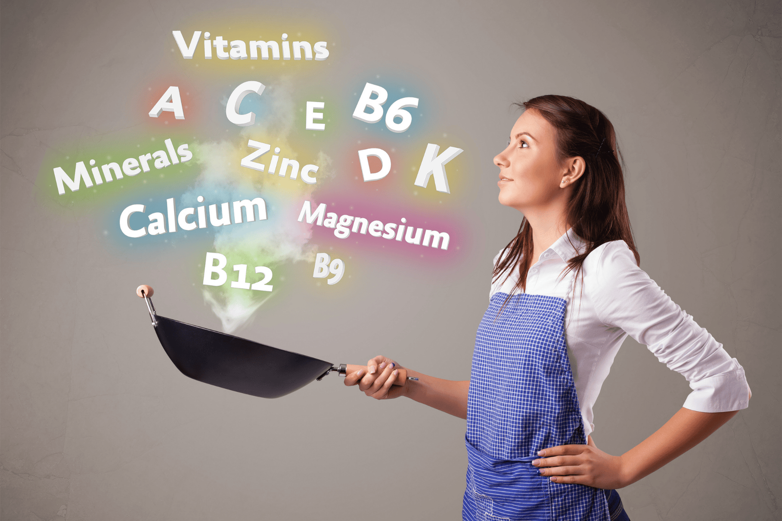 Woman in an apron holding a frying pan as colorful words for vitamins and minerals (A, C, D, B12, calcium, zinc, magnesium, etc.) float above.