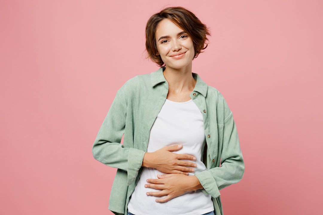 Pregnant woman with healthy gut, choosing safe greens powder.